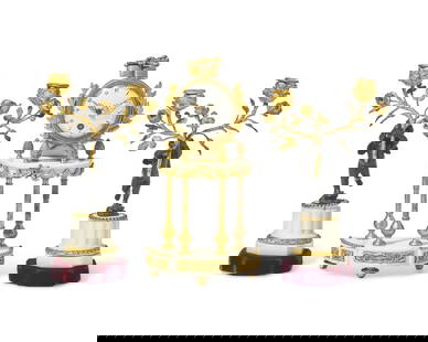 A Louis XVI Style Gilt and Patinated Bronze Mounted White Marble Three-Piece Clock Garniture: A Louis XVI Style Gilt and Patinated Bronze Mounted White Marble Three-Piece Clock Garniture Probably French, Late 19th Century comprising a clock with enamel dial, and two candlesticks in the form