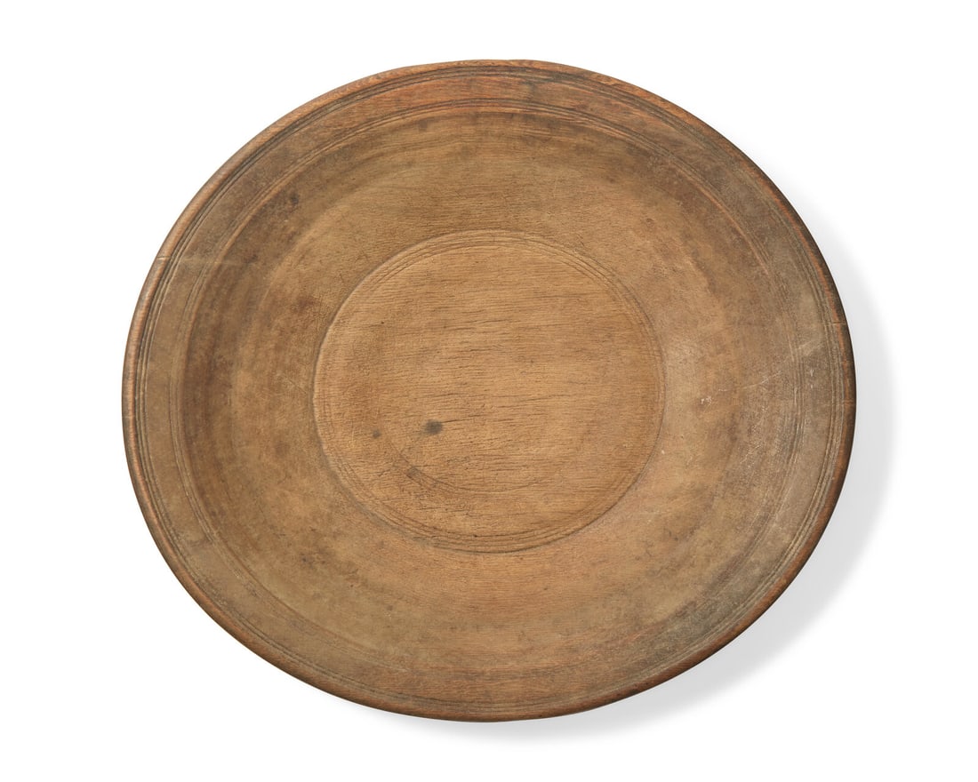A Turned Wood Charger: A Turned Wood Charger 18th Century old surface, incised banding. Height 2 1/4 x width 18 1/4 x depth 16 1/2 inches. This lot is located in Philadelphia. Provenance: Collection of Ron Hoffman and Tony