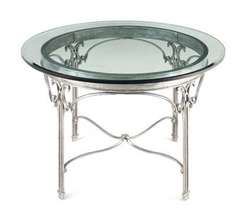 A Polished Steel Side Table: A Polished Steel Side Table 20th Century having a glass top. Height 29 x diameter 45 1/2 inches. This lot is located in Chicago. 
