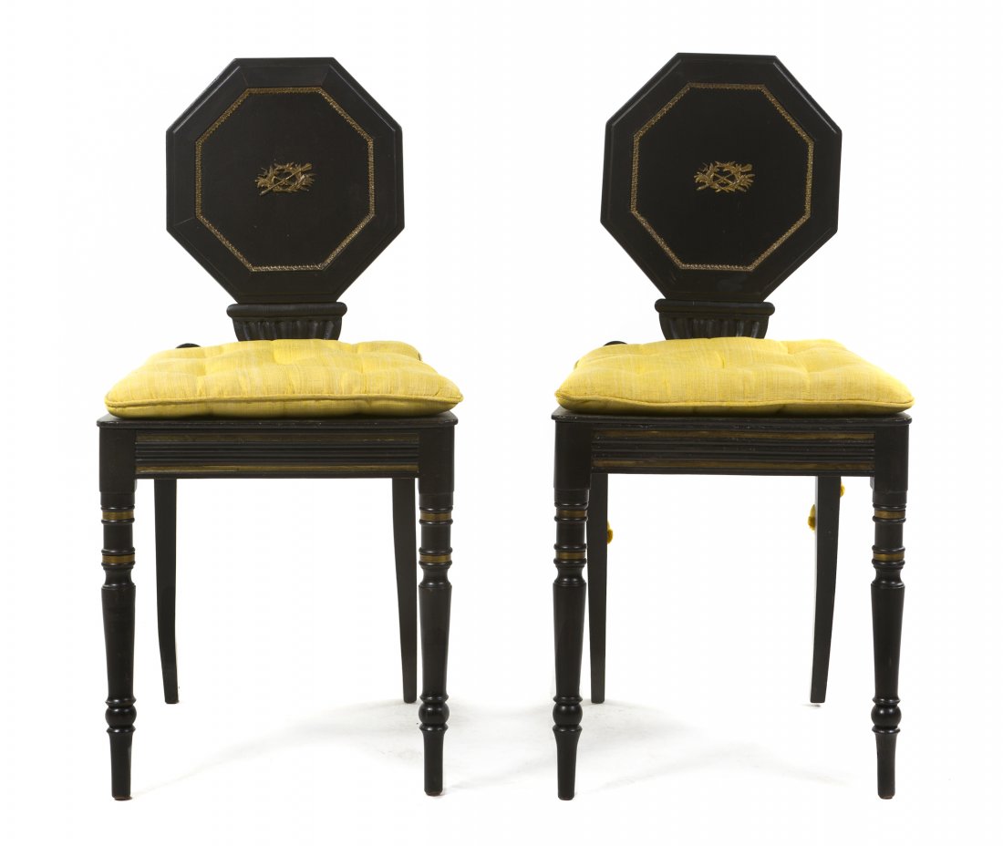 A Pair of English Ebonized and Parcel Gilt Hall Chairs,: A Pair of English Ebonized and Parcel Gilt Hall Chairs, each with an octagonal back and trapezoidal seat, raised on turned legs. Height 35 inches.