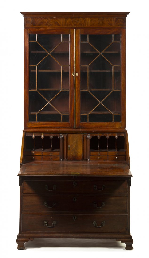A George III Mahogany Secretary Bookcase, Height 92 x w: A George III Mahogany Secretary Bookcase, the superstructure having a molded cornice above a plain frieze and two astragal glazed doors, opening to adjustable shelves, set on the case with a slant fro