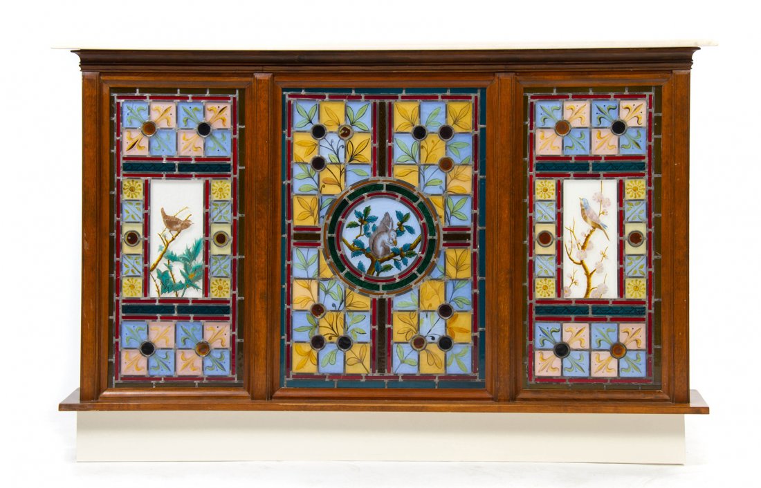 A Set of Three American Stained and Leaded Glass Window: A Set of Three American Stained and Leaded Glass Windows, having foliate, fleur-de-lis, bird and swirl decoration, set in a later pine side unit with a marble top and electrified for back lighting. He