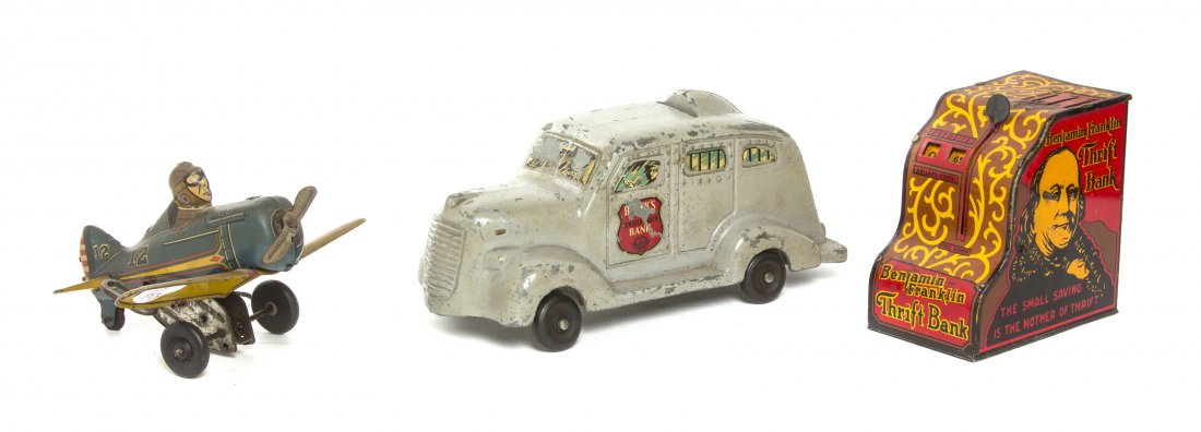 An American Tin Litho Wind-Up Toy, Marx, Width of wides: An American Tin Litho Wind-Up Toy, Marx, depicting a pilot in an airplane with a flip over mechanism, together with a Brinks armored truck bank and a Benjamin Franklin Thrift bank. Width of widest 8 1