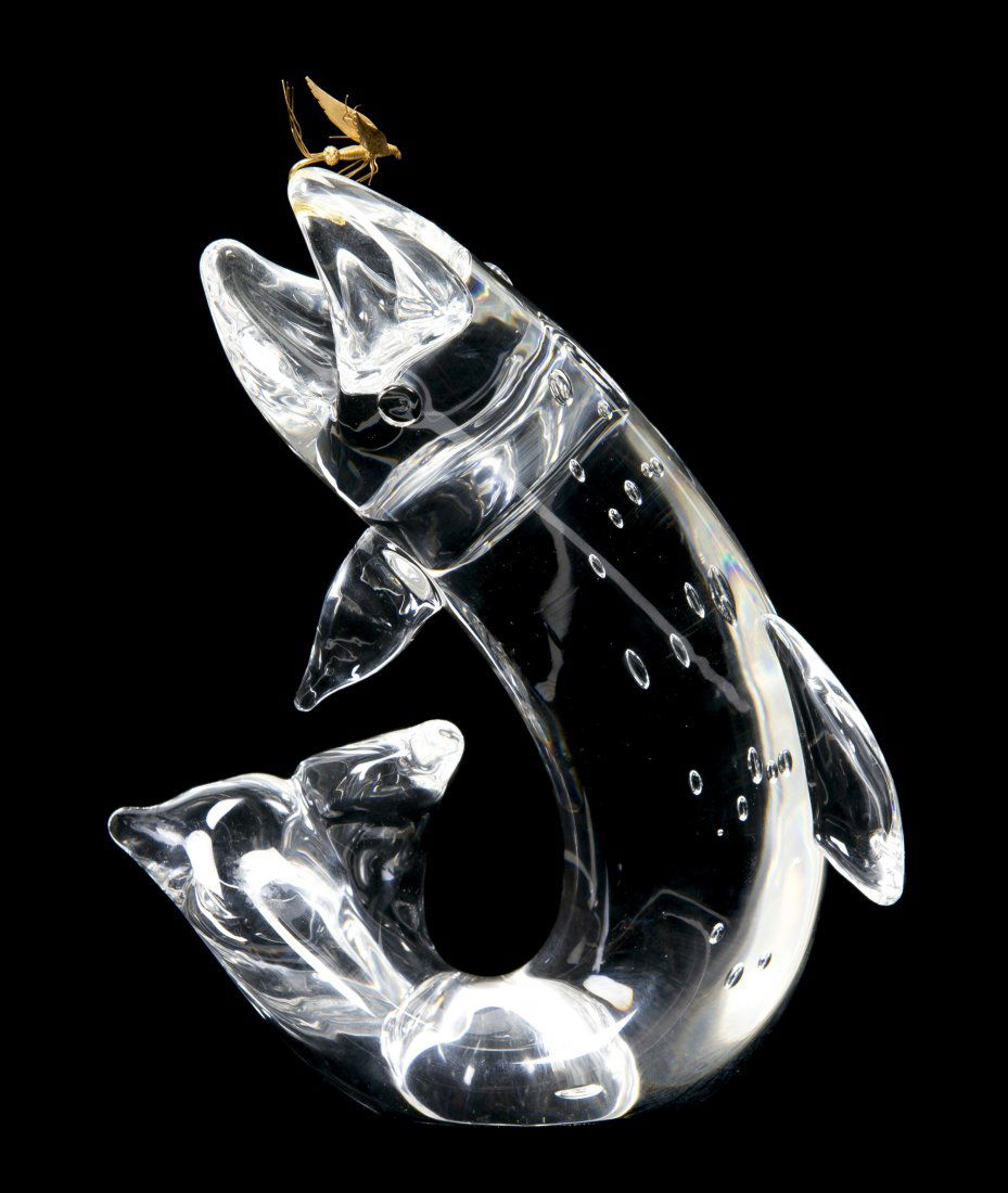 A Steuben Glass and 18 Karat Gold Trout and Fly Figure,: A Steuben Glass and 18 Karat Gold Trout and Fly Figure, model 1002, designed by James Houston in 1966, the fish depicted with internal air bubble decoration and a gold lure, with Steuben fitted case.
