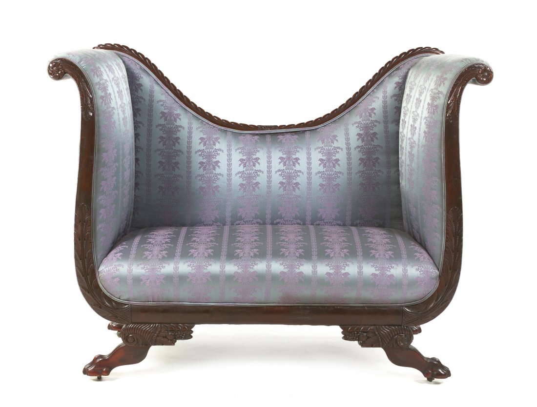 An American Classical Mahogany Settee, Width 61 inches.: An American Classical Mahogany Settee, 19th century, having a concave gadrooned crest rail over the upholstered back, arms and seat, raised on cornucopia form supports over the paw feet ending in cast