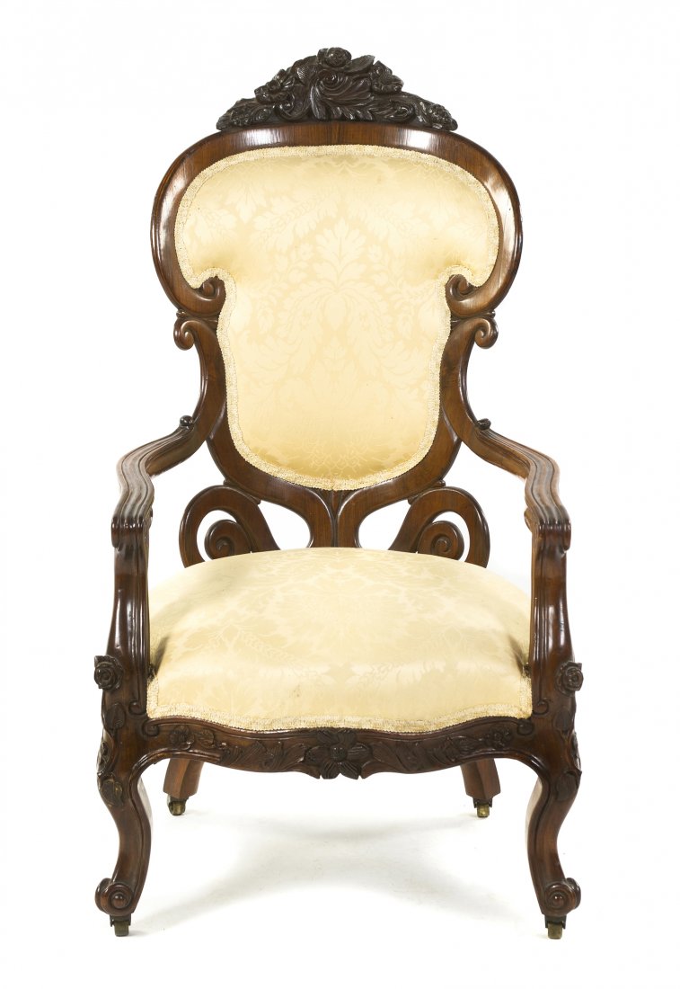 A American Mahogany Armchair, Belter, Height 42 inches.: A American Mahogany Armchair, Belter, in the Rosalie pattern, having a foliate carved crest over the upholstered back and seat, raised on carved cabriole legs ending in casters. Height 42 inches.