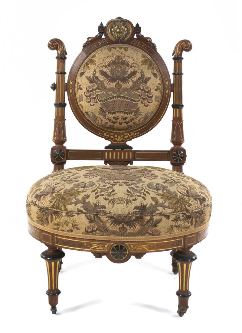 A Late Victorian Parcel Gilt and Ebonized Slipper Chair: A Late Victorian Parcel Gilt and Ebonized Slipper Chair, in the manner of Herter Brothers, New York, circa 1880, having a rounded crest with lion mask decoration over the upholstered back and seat, ra