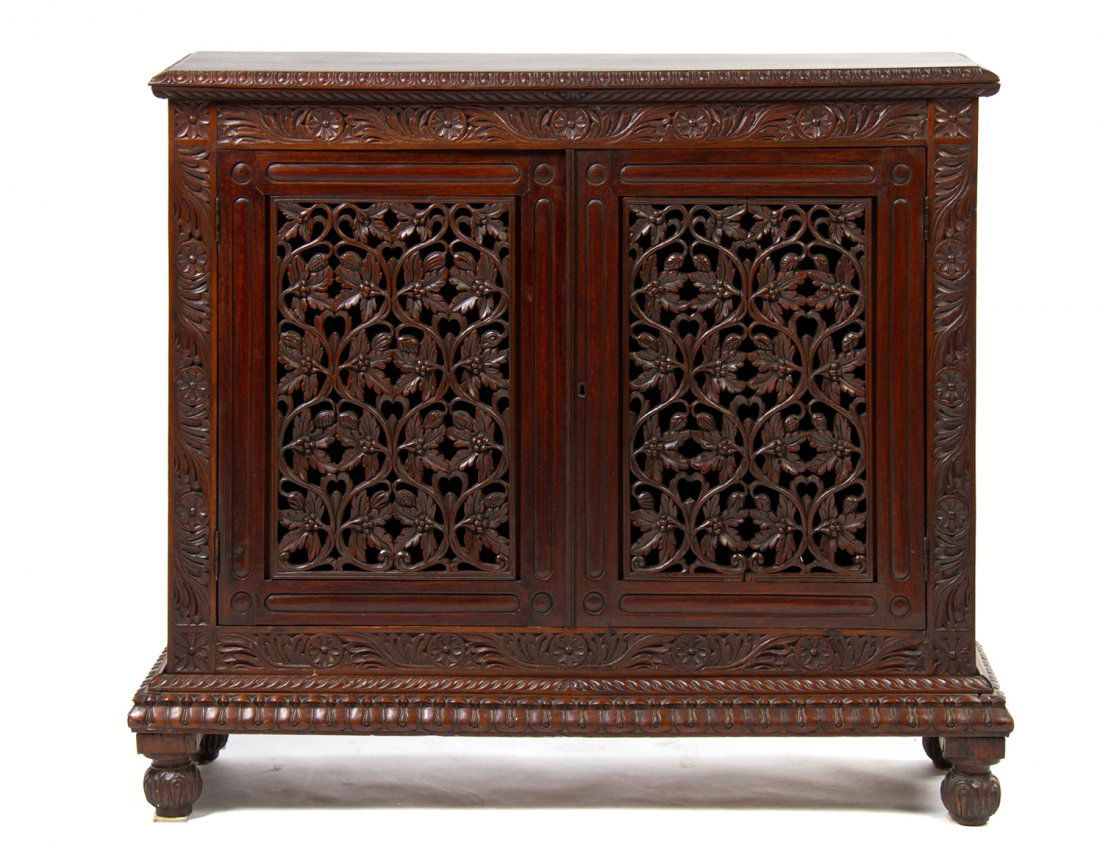 A Victorian Mahogany Pie Safe, Height 43 x width 48 1/2: A Victorian Mahogany Pie Safe, having a rectangular top over two pierce carved doors opening to a shelved interior, raised on carved ball feet. Height 43 x width 48 1/2 x depth 14 1/4 inches.