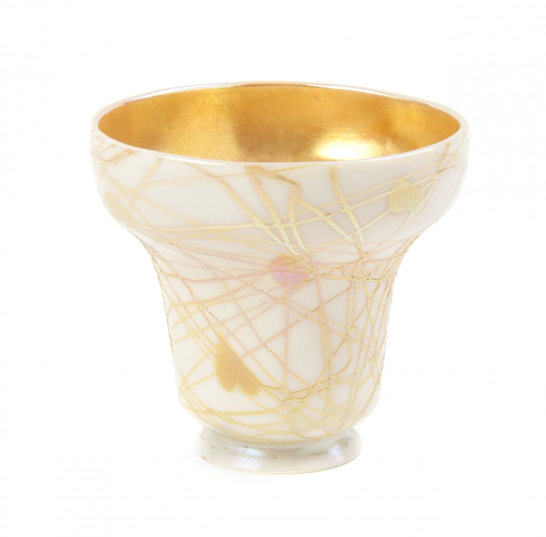 An American Iridescent Glass Shade, attributed to Duran: An American Iridescent Glass Shade, attributed to Durand, of bell form with heart and applied string decoration on a cream ground, the interior with gold iridescence. Height 4 5/8 inches.
