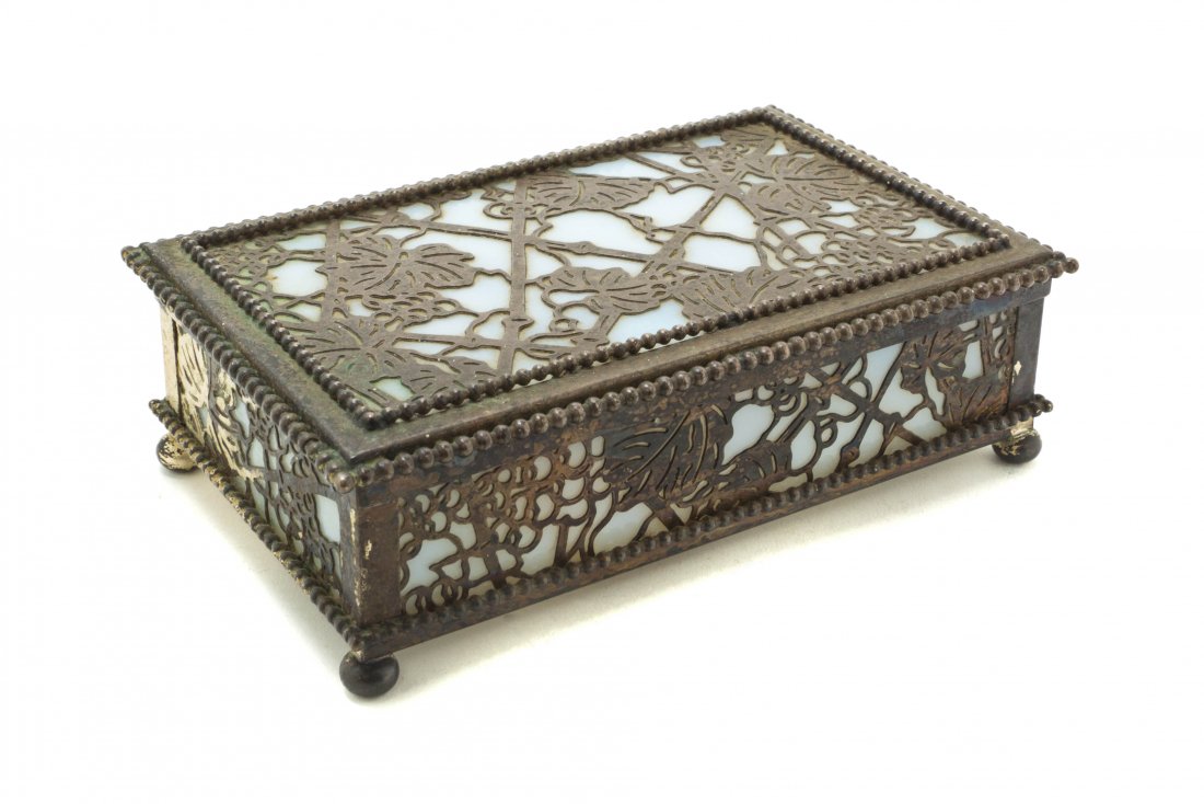 A Tiffany Studios Parcel Silvered Bronze and Favrile Gl: A Tiffany Studios Parcel Silvered Bronze and Favrile Glass Box, in the Grapevine pattern, set with opaque white inserts, stamped Tiffany Studios, New York, 809, 9. Width 6 5/8 inches.