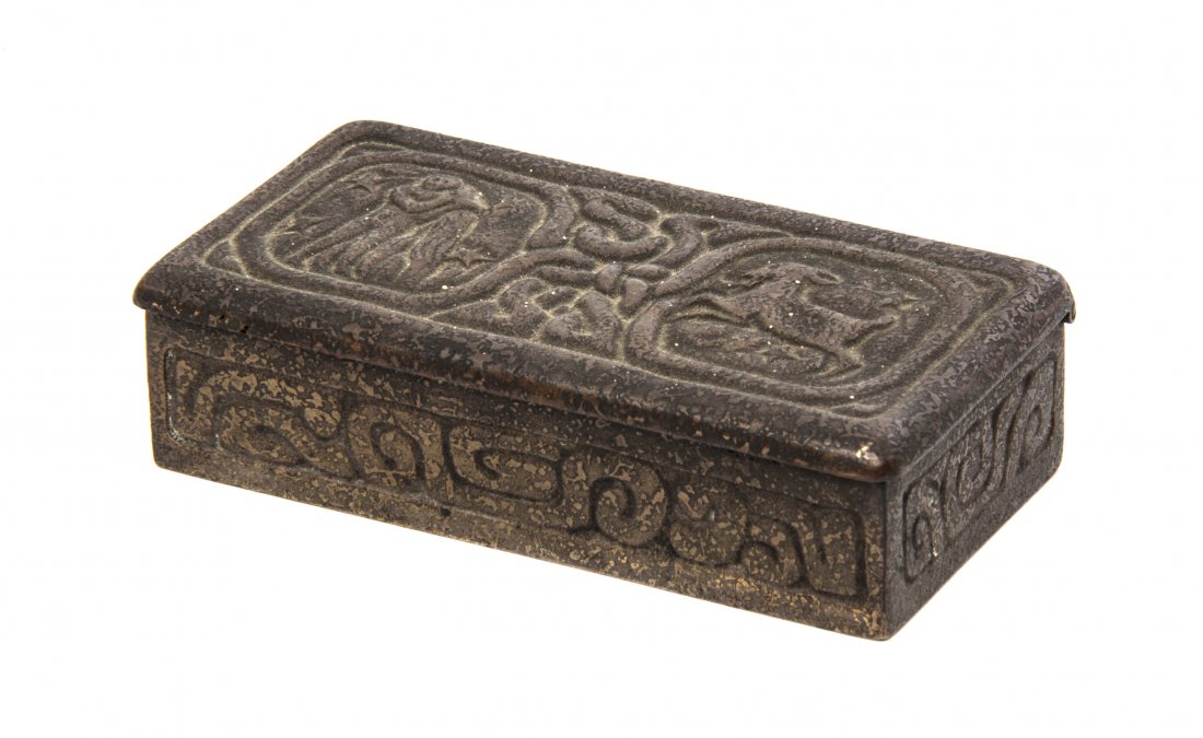 A Tiffany Studios Dore Bronze Stamp Box, Width 3 3/4 in: A Tiffany Studios Dore Bronze Stamp Box, in the Zodiac pattern, stamped Tiffany Studios, New York, 802. Width 3 3/4 inches.