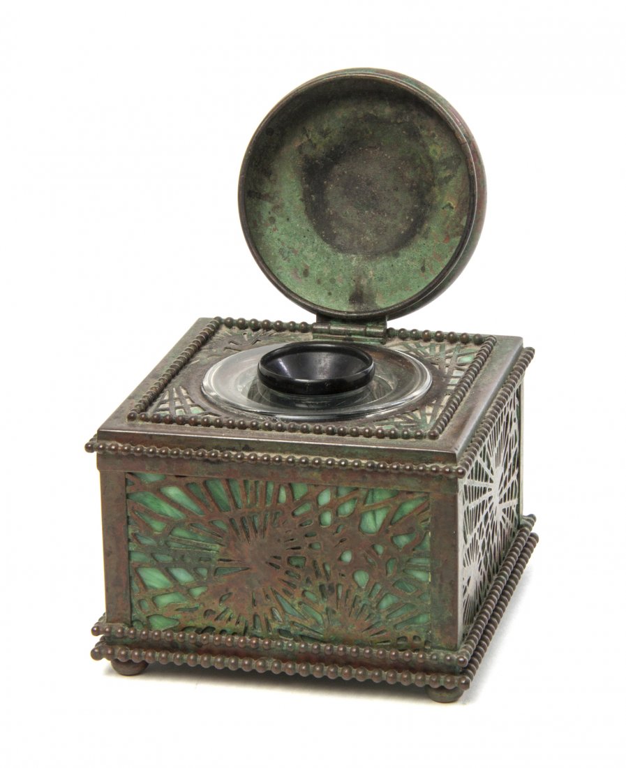 A Tiffany Studios Patinated Bronze Inkwell, Height 3 1/: A Tiffany Studios Patinated Bronze Inkwell, in the Pine Needle pattern, stamped Tiffany Studios, New York, 844. Height 3 1/2 x width 4 1/8 x depth 4 1/8 inches.