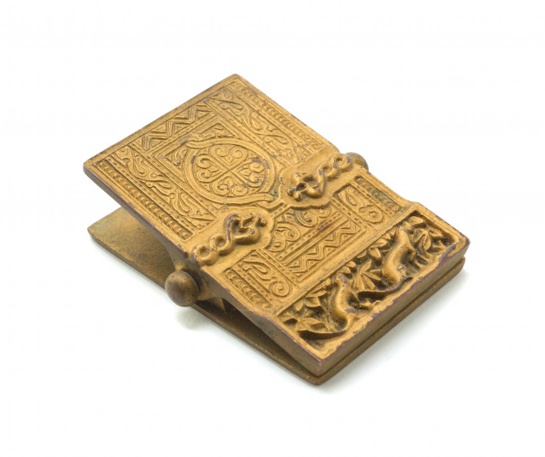 A Tiffany Studios Gilt Bronze Note Clip, Length 3 3/8 i: A Tiffany Studios Gilt Bronze Note Clip, in the Venetian pattern, stamped Tiffany Studios, New York, 1693. Length 3 3/8 inches.