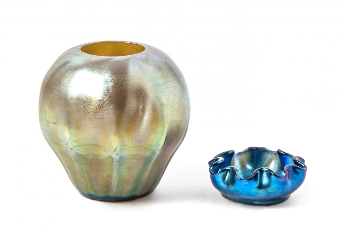 Two Tiffany Studios Favrile Glass Articles, Height of f: Two Tiffany Studios Favrile Glass Articles, comprising a vase of ovoid form in gold iridescence with ribbed decoration, signed L.C.T. 5257, the second a salt cellar with a ruffled rim in blue iridesce