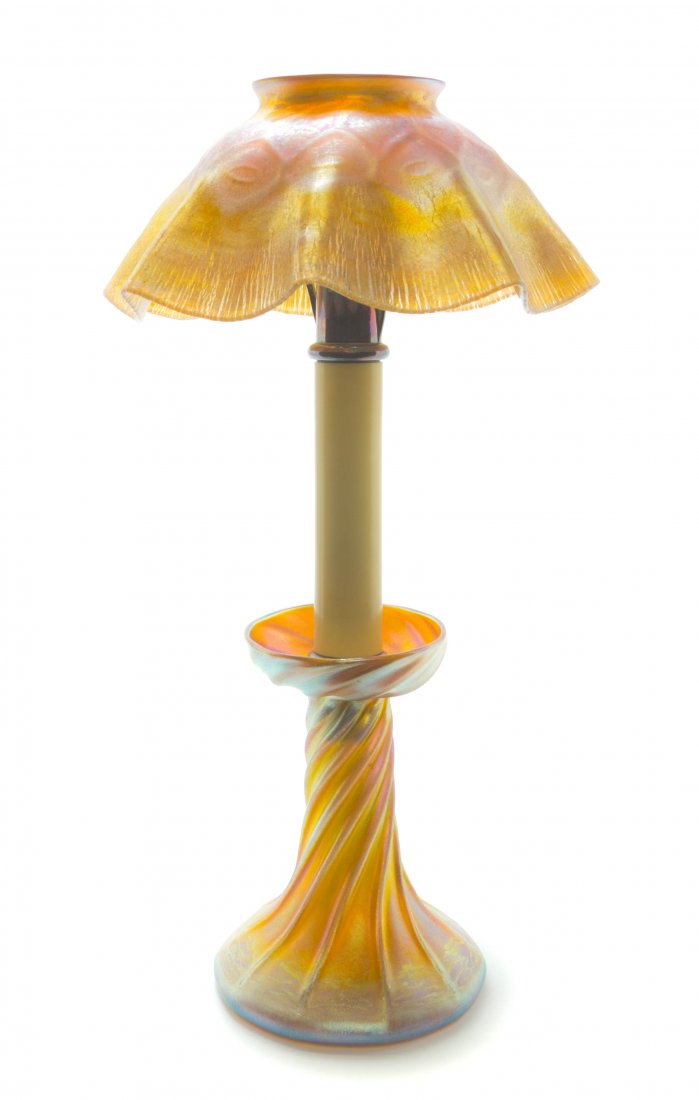 A Tiffany Studios Gold Favrile Glass Candlestick Lamp, : A Tiffany Studios Gold Favrile Glass Candlestick Lamp, having a quilted and ruffled gold shade over the silvered and composite insert, raised on a twisted base, the shade and base signed L.C.T. Height