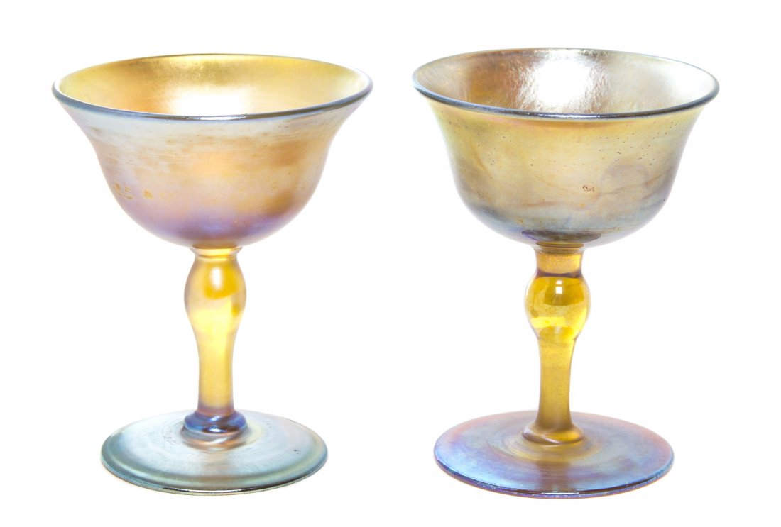 A Near Pair of Tiffany Studios Gold Favrile Glass Goble: A Near Pair of Tiffany Studios Gold Favrile Glass Goblets, each having an inverted bell form bowl raised on a baluster stem and circular foot, signed L.C.T. Favrile, one further numbered 307. Height 3