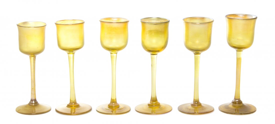 An Assembled Set of Six Tiffany Studios Gold Favrile Gl: An Assembled Set of Six Tiffany Studios Gold Favrile Glass Cordials, each with a slightly flared cylindrical bowl over the slender stem raised on a circular foot, signed L.C.T Favrile. Height of talle