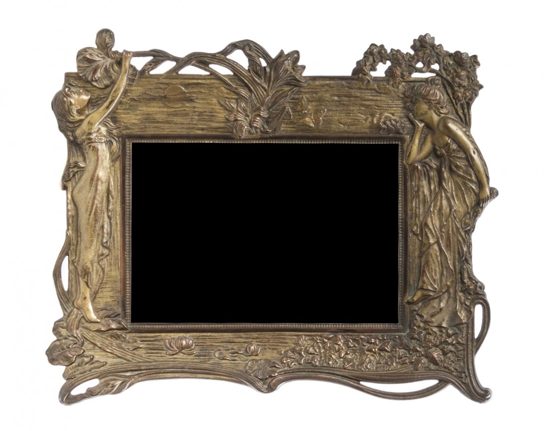 An Art Nouveau Cast Metal Table Mirror, Height 10 7/8 x: An Art Nouveau Cast Metal Table Mirror, having two maidens and scrolling foliate decoration. Height 10 7/8 x width 14 inches. Property from the Estate of Evelyn Stefani, Inverness, Illinois