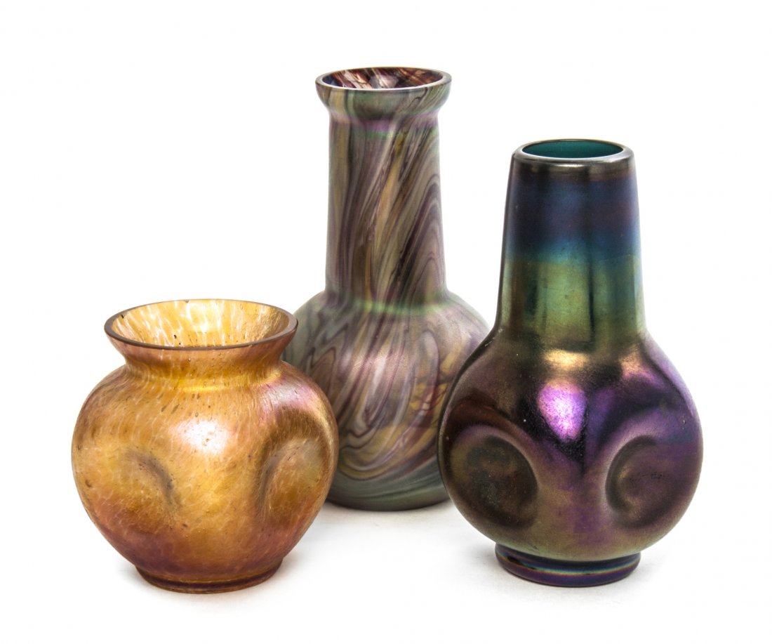 Two Iridescent Glass Vases, in the manner of Loetz, Hei: Two Iridescent Glass Vases, in the manner of Loetz, each of pinched form, together with a swirled glass bottle form vase. Height of tallest 5 3/4 inches. Property from the Estate of Chrystian Aubusson