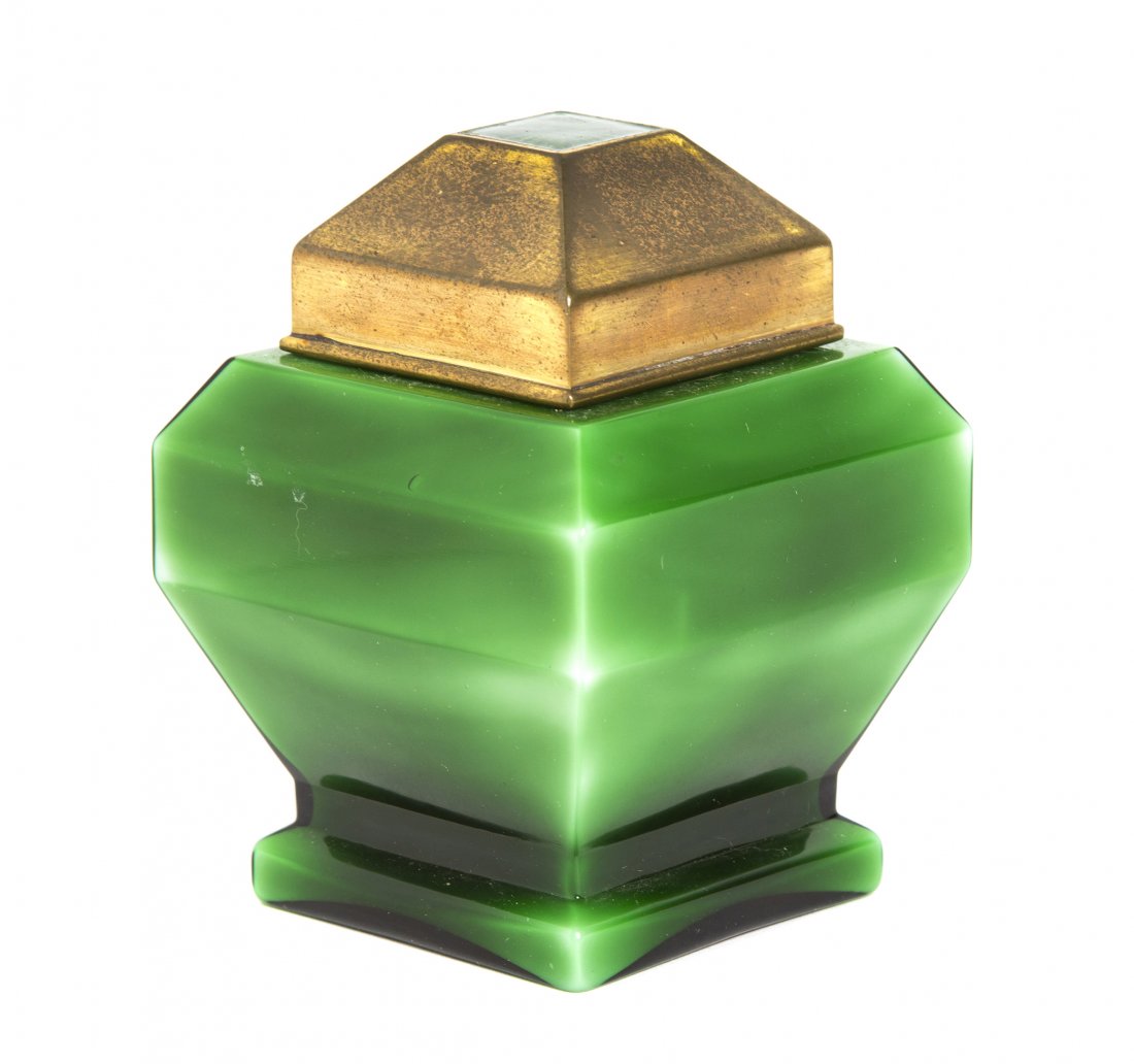 A French Art Deco Emerald Glass Perfume Bottle, Baccara: A French Art Deco Emerald Glass Perfume Bottle, Baccarat for Myon, Coeur de Femme, of squared faceted form, the conforming gilt metal lid set with guilloche enameled decoration. Height 3 3/8 inches.