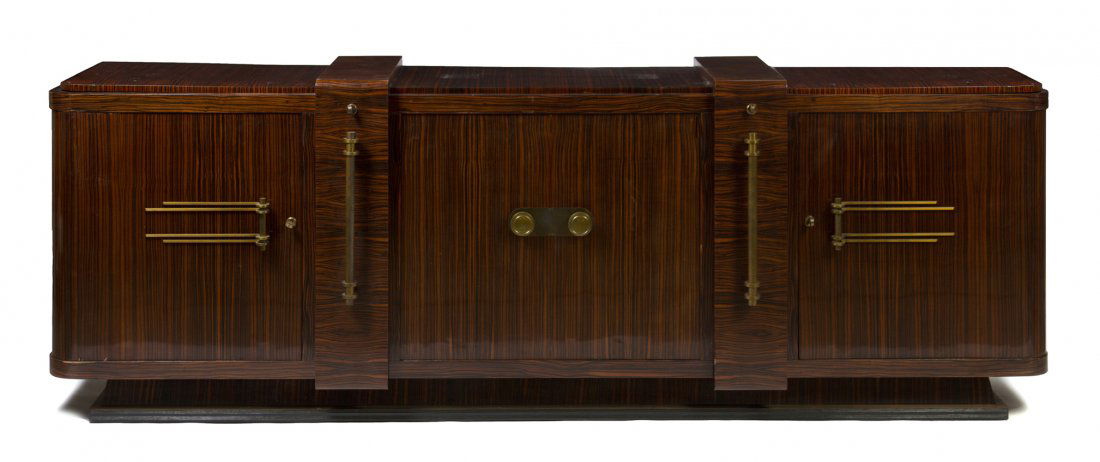 An Art Deco Rosewood Sideboard, in the manner of Jules : An Art Deco Rosewood Sideboard, in the manner of Jules Leleu, of rectangular form with rounded corners, having two central doors flanked by storage drawers and doors, raised on a plinth base. Height 3