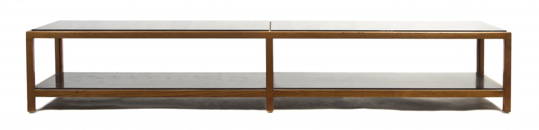 An Edward Wormley Walnut and Laminate Coffee Table, for: An Edward Wormley Walnut and Laminate Coffee Table, for Dunbar, of elongated rectangular form raised on square legs, joined by a medial shelf. Height 15 1/2 x width 85 1/2 x depth 15 1/2 inches. Prope