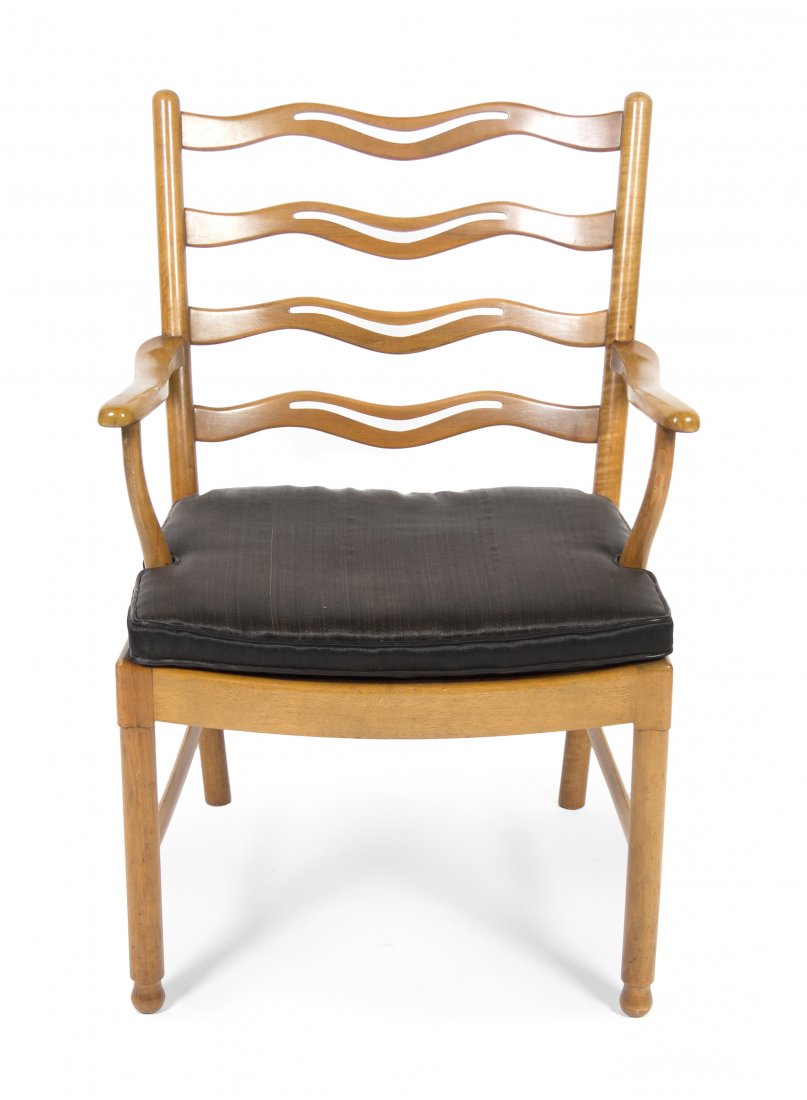 A Danish Beechwood Armchair, Ole Wanscher (1903-1985) f: A Danish Beechwood Armchair, Ole Wanscher (1903-1985) for Fritz Hansen, having repeating pierced wave form back splats, over a plank seat with a conforming upholstered cushion, raised on cylindrical l