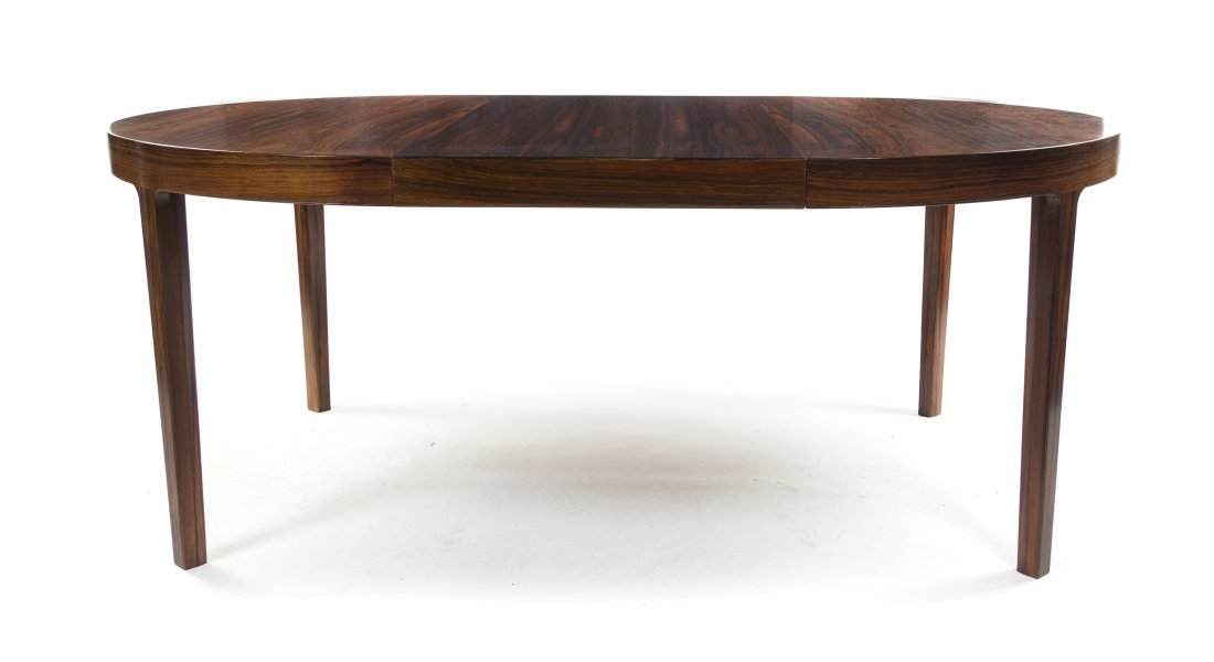A Danish Rosewood Extension Dining Table, Ole Wanscher : A Danish Rosewood Extension Dining Table, Ole Wanscher (1903-1985) for Ilums Bolighus, having a circular top raised on squared legs, with three leaves. Diameter without leaves 49 1/4 inches.