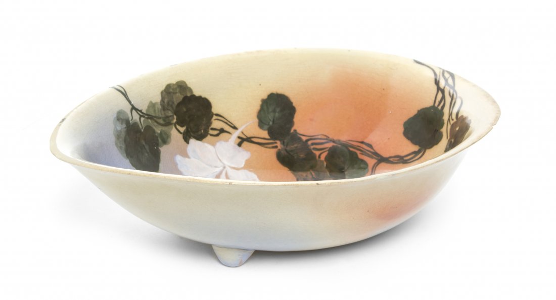 A Rookwood Pottery Bowl, Matthew Andrew Daly, Width 10 : A Rookwood Pottery Bowl, Matthew Andrew Daly, 1887, of ovoid form with two applied feet decorated with flowering vines having standard mark further numbered 316/Y. Width 10 7/8 inches.