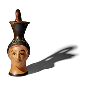 A Greek Painted Terracotta Figural Oinochoe