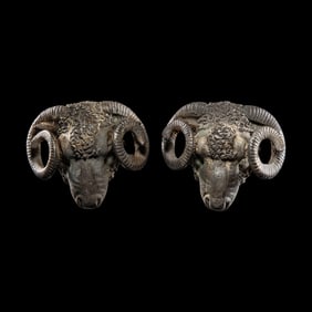 A Pair of Hellenistic Silver Ram's Head Appliques