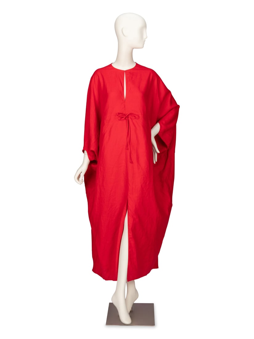 RALPH RUCCI, SCARLET LINEN KAFTAN: RALPH RUCCI, SCARLET LINEN KAFTAN Draped kaftan in scarlet red linen. Round neckline with slit at chest. Three quarter-length dolman sleeves. Decorative ties at front waist. Knee-high slit at front he
