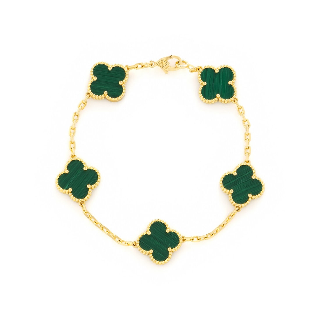 VAN CLEEF AND ARPELS, YELLOW GOLD AND MALACHITE 'ALHAMBRA' BRACELET: VAN CLEEF AND ARPELS, YELLOW GOLD AND MALACHITE 'ALHAMBRA' BRACELET Five malachite quatrefoil stations. 18 karat yellow gold. 7 1/4 inches long. Stamp: VCA Au750 5582 Gross weight: 4.60 dwt. Accompani