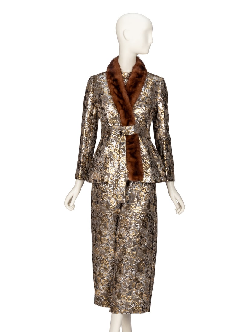 MOLLIE PARNIS, BROCADE JUMPSUIT ENSEMBLE: MOLLIE PARNIS, BROCADE JUMPSUIT ENSEMBLE Label: Mollie Parnis Retail Label: Saks Fifth Avenue Size Label: 8 Date: 1970s Country of Origin: USA JACKET Wrap-style jacket in gold & silver lamé b