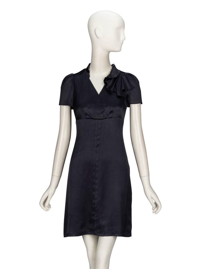 PRADA, DEEP GREY SATIN DRESS: PRADA, DEEP GREY SATIN DRESS Day dress in anthracite satin. V neckline with asymmetric ruffle collar. Cap sleeves. Self-fabric flounce at upper chest. Empire waistline with slightly flared knee-length
