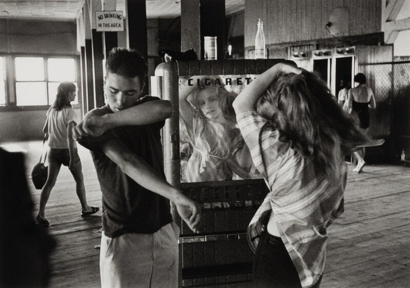 Bruce Davidson (American, b. 1933) Cathy Fixing her Hair in Cigarette Machine Mirror (from Brooklyn : Bruce Davidson (American, b. 1933) Cathy Fixing her Hair in Cigarette Machine Mirror (from Brooklyn Gang), 1959 gelatin silver print signed in pencil, verso 12 5/8 x 18 3/4 inches.