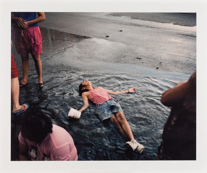 Paul D'Amato (American, b.1956) Girl in Rain, Chicago, 1991; printed 2006: Paul D'Amato (American, b.1956) Girl in Rain, Chicago, 1991; printed 2006 archival inkjet photograph signed, titled, bearing negative date, and numbered 1/10 in pencil 31 3/4 x 40 inches.