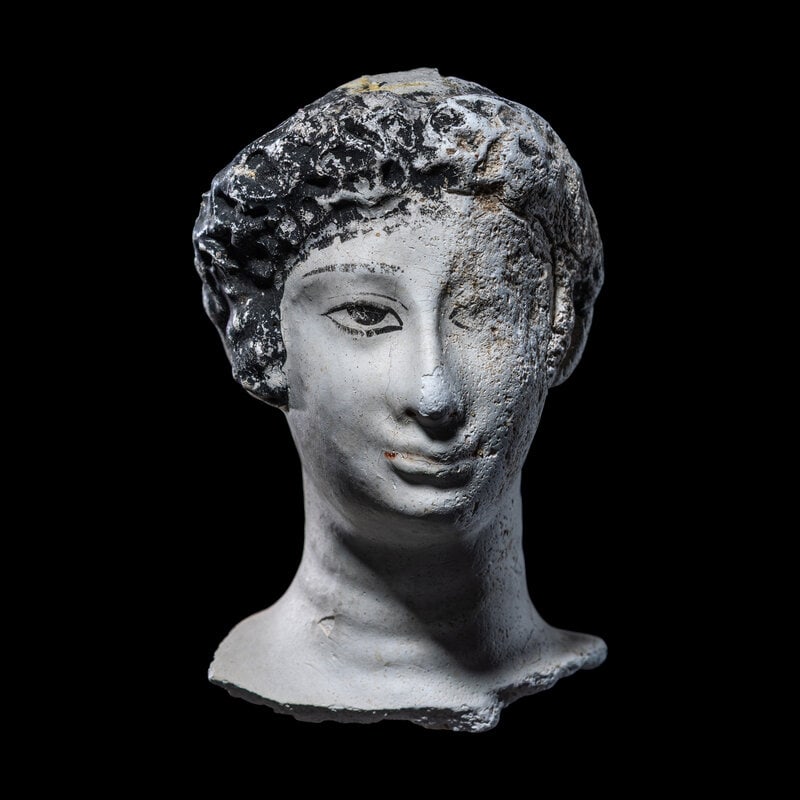 An Egyptian Painted Stucco Mummy Mask: An Egyptian Painted Stucco Mummy Mask Roman Period, Circa 1st Century B.C.-1st Century A.D. Height 10.8 cm (4 1/4 inches). This lot is located in Chicago. Size
