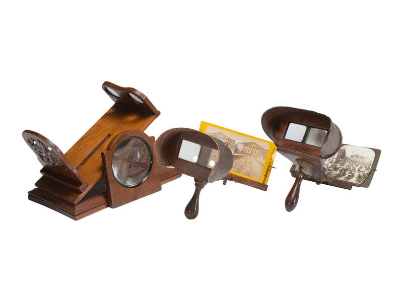 [STEREOVIEWS]. Three vintage stereoscopes, incl. tabletop example. [With:] Stereoviews and poster.  (1 of 3)