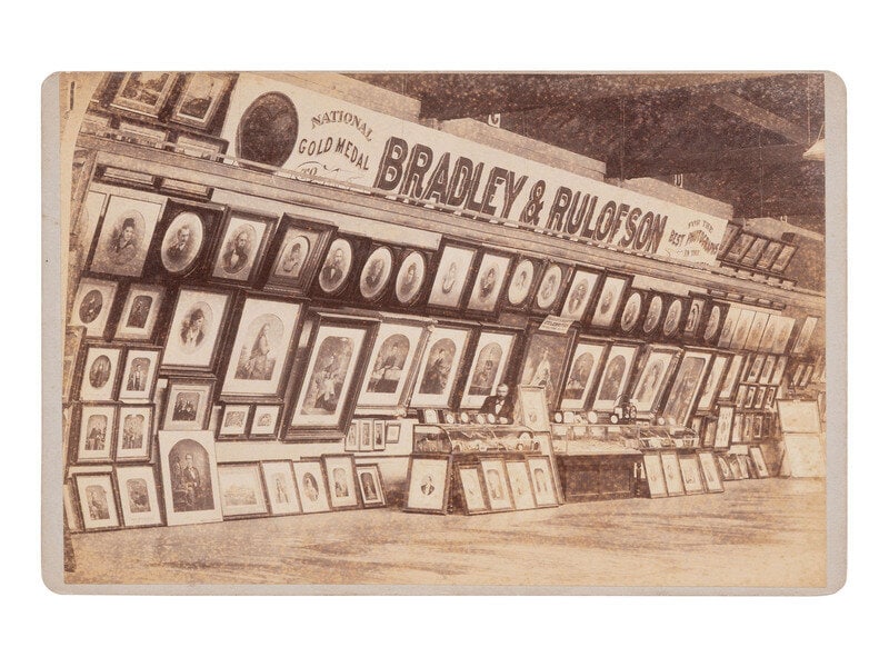 [EARLY PHOTOGRAPHY]. Cabinet card of an advertising display for BRADLEY & RULOFSON at an exhibit.  (1 of 2)