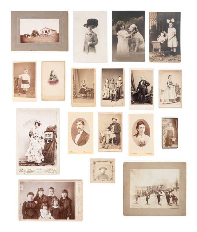 [EARLY PHOTO] Collection of paper photos, incl. CDVs, cabinet cards, RPPCs, silver gelatin prints.: [EARLY PHOTO] Collection of paper photos, incl. CDVs, cabinet cards, RPPCs, silver gelatin prints. 18 CDVs, highlighted by a portrait of a young girl holding her doll on the cushion of a chair and loo