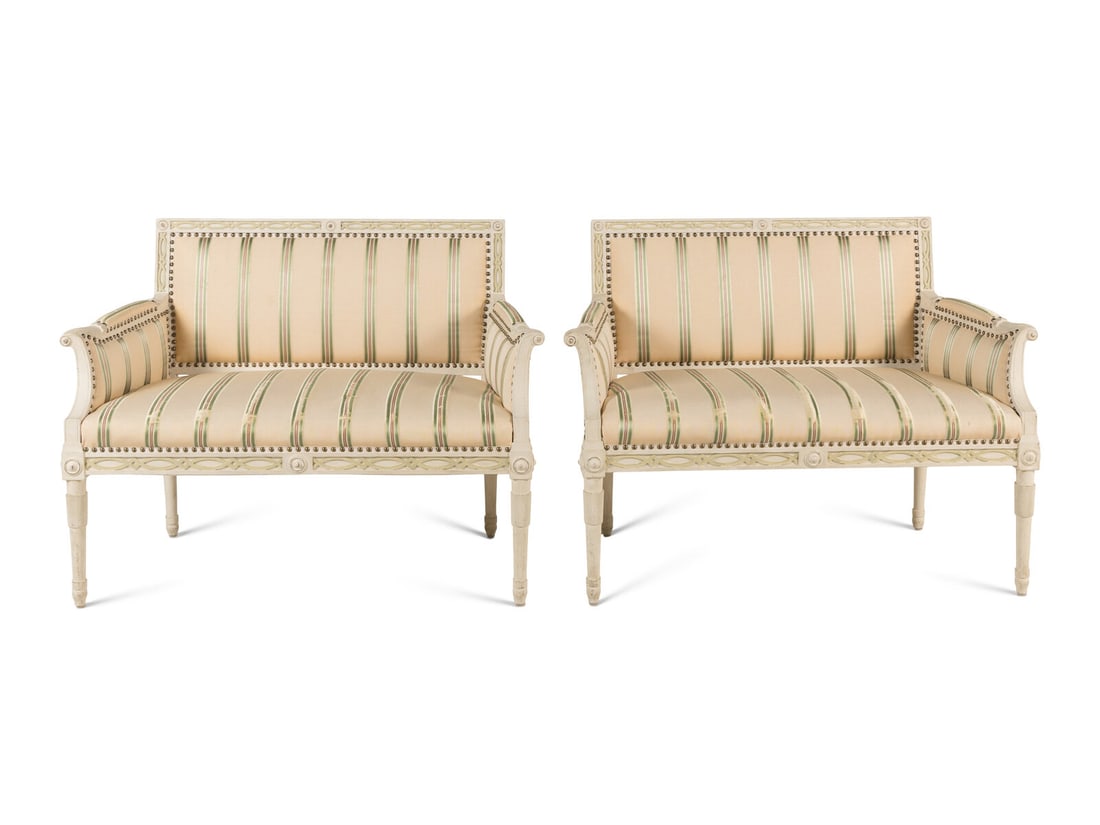 A Pair of Gustavian Style White-Painted Settees: A Pair of Gustavian Style White-Painted Settees 20th Century Height 33 1/4 x width 44 1/2 x depth 26 inches. Property from Camp Rosemary, the Estate of Posy Krehbiel, Lake Forest, Illinois This lot is