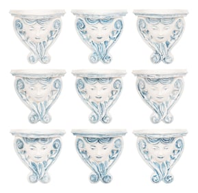 A Set of Nine Blue and White Plaster Wall Brackets