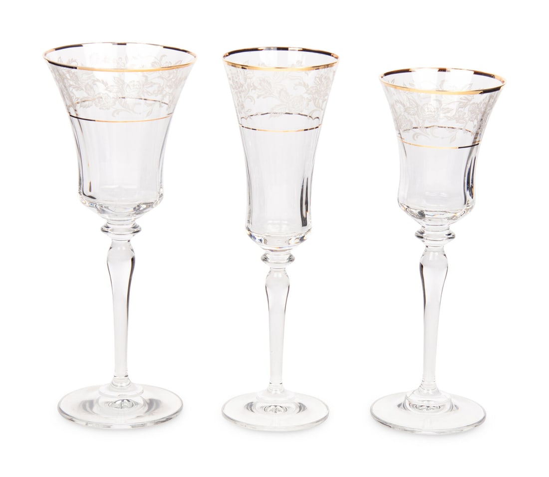 A Gilt Banded and Floral Etched Glass Stemware Service: A Gilt Banded and Floral Etched Glass Stemware Service comprising: 36 white wine stems 17 red wine stems 11 champagne flutes; 64 items total. Height of red wine stem 9 inches. Property from Camp Rosem