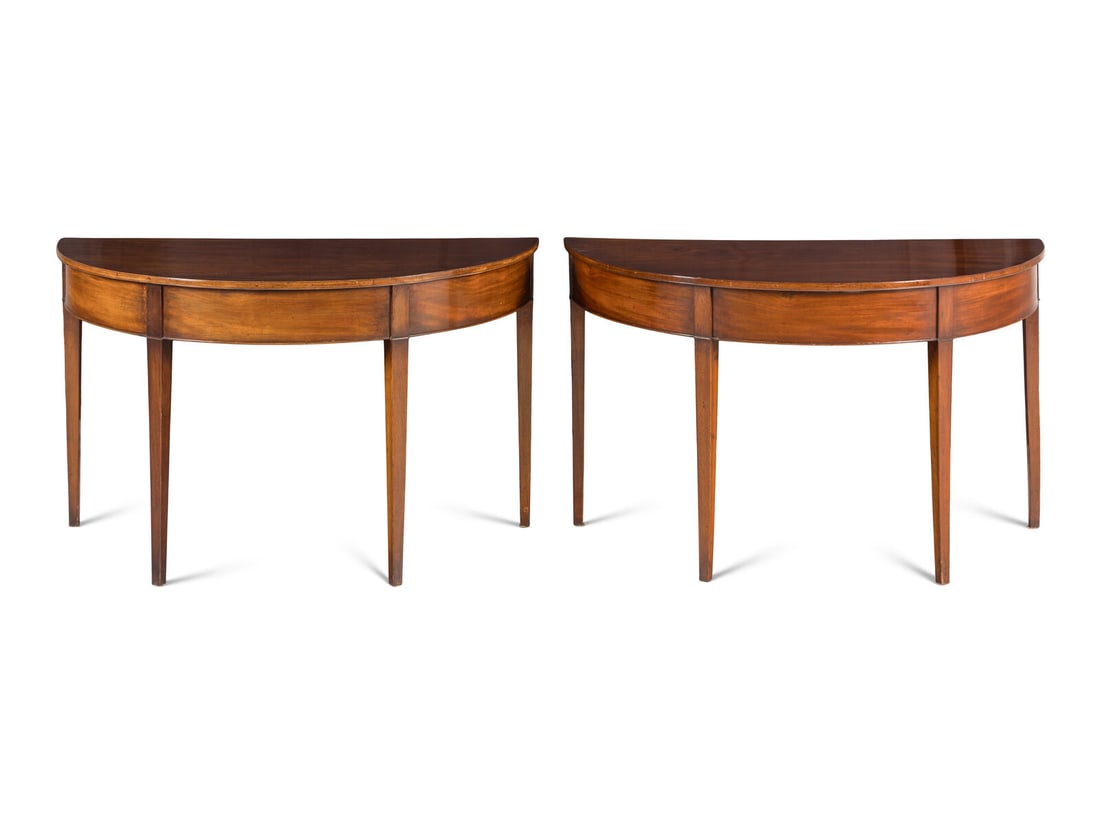 A Pair of George III Mahogany Demilune Console Tables: A Pair of George III Mahogany Demilune Console Tables 19th Century Height 28 3/4 x width 48 x depth 24 inches. Property from Camp Rosemary, the Estate of Posy Krehbiel, Lake Forest, Illinois This lot
