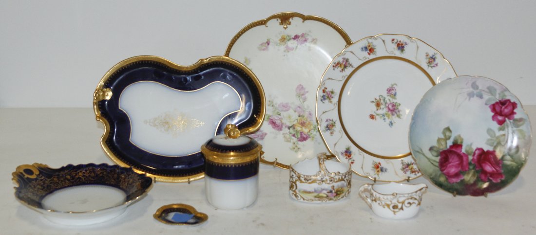 A Collection of French Porcelain Table Articles, Diamet: A Collection of French Porcelain Table Articles, primarily Limoges, comprising two chargers, a plate, a set of graduated vases, a creamer and sugar set, and three cobalt trays of various sizes. Diamet