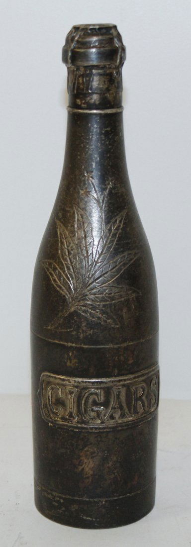 An American Silverplate Humidor, Pairpoint Mfg. Co., He: An American Silverplate Humidor, Pairpoint Mfg. Co., in the form of a champagne bottle, labeled Cigars, stamped Pairpoint Mfg. Co, Quadruple Plate, 1921 to the underside. Height 10 1/2 inches. Propert