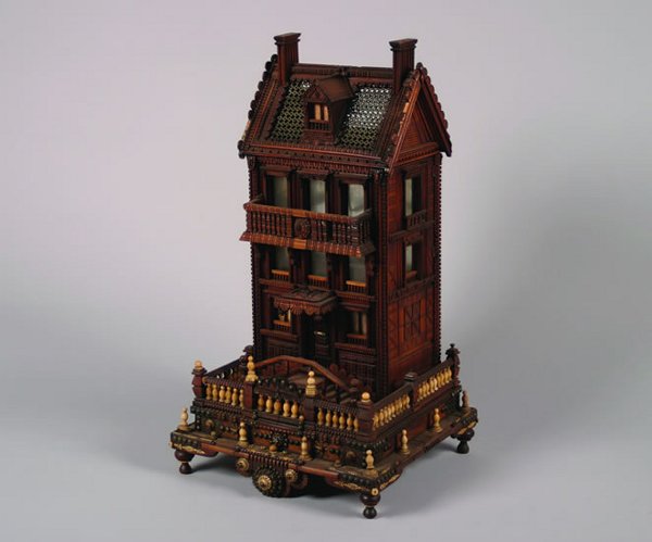An American Tramp Art Wood and Bone Bird: An American Tramp Art Wood and Bone Birdcage, late 19th century, elaborately constructed in the form of a Victorian house, rasied on a square base with turned feet, losses to bone and wood. Height 34