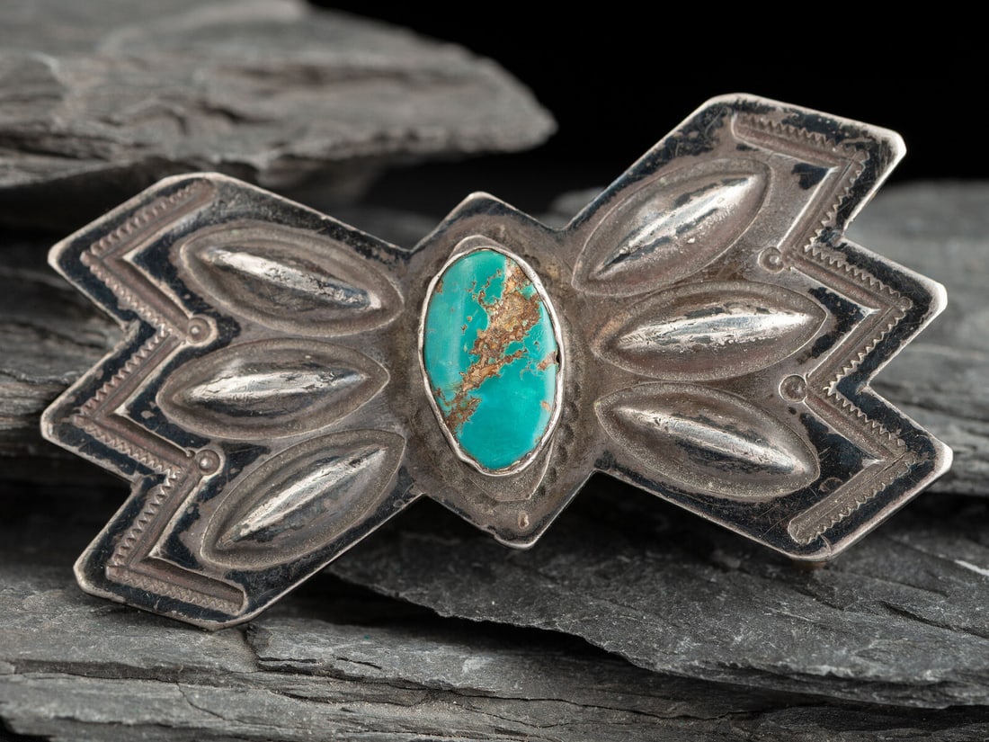 Navajo Silver and Turquoise Belt Buckle: Navajo Silver and Turquoise Belt Buckle second quarter - mid 20th century made from a repurposed butterfly from a concha belt, with stamped edges and repoussé elements accenting the central turqu