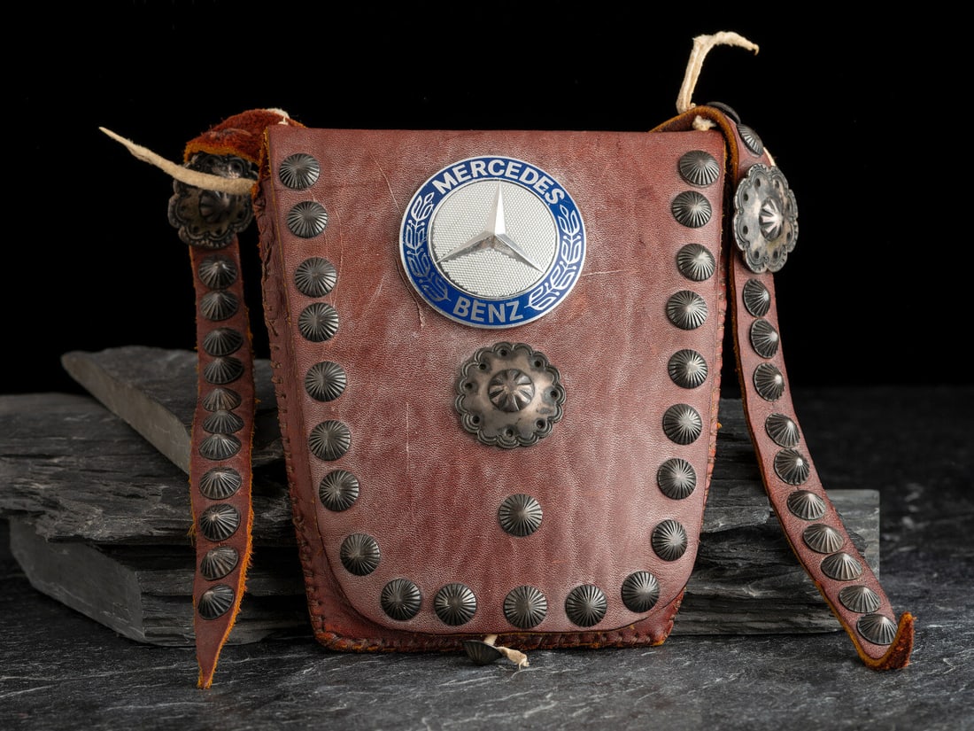 Navajo Bandolier Button Bag: Navajo Bandolier Button Bag third quarter 20th century features a prominent, large Mercedes-Benz button along with an assortment of fluted and stamped buttons overall length 35 inches, bag length 6-1/